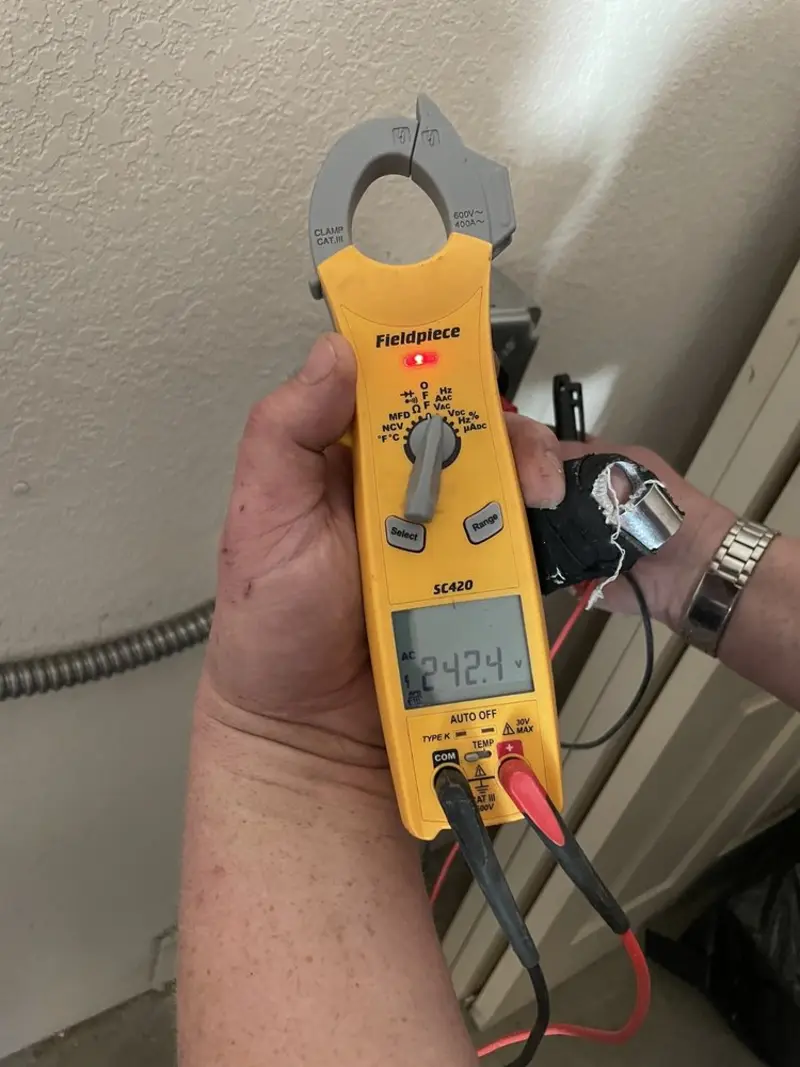 Voltage testing with clamp meter during Generator Installation in Mountain View Acres